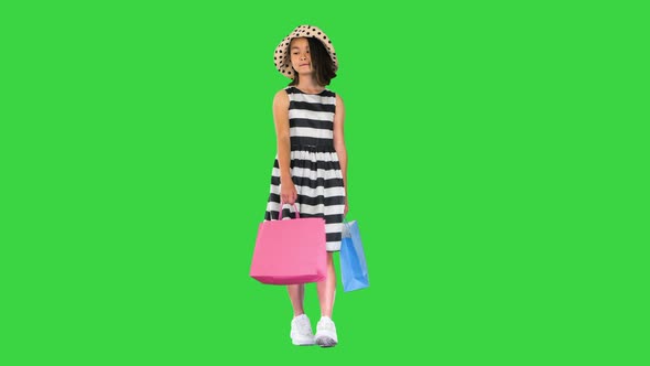 Asian Shopping School Girl Walking and Smiling on a Green Screen, Chroma Key.