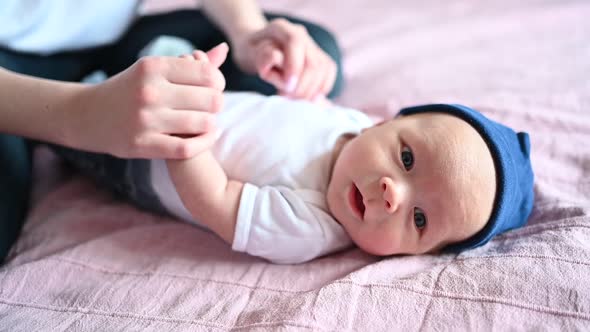 A Baby Lying on a Bed