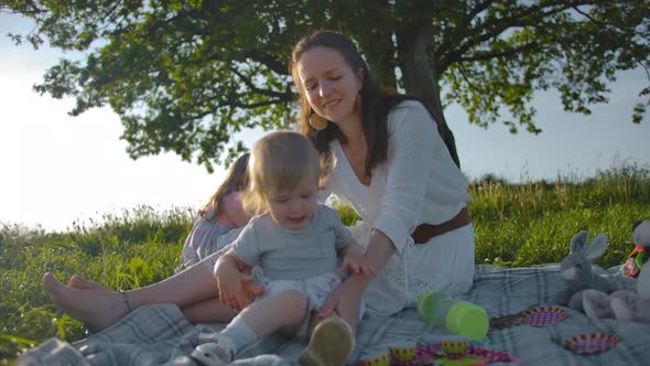 Mom Holds Her Little Daughter in Her Arms and Then Lets Her Go, Girl Falls and Begins To Cry Loudly.