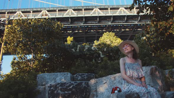 Smiling woman at the bridge in the park