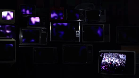 Blurred People at a Concert or Disco On Retro TVs.