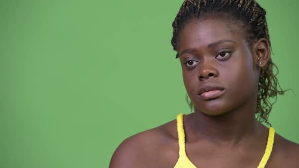 Young African Woman Against Green Background