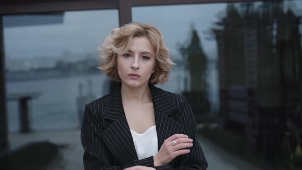 Portrait of Confident Lady Crossing Hands at Camera Outdoors