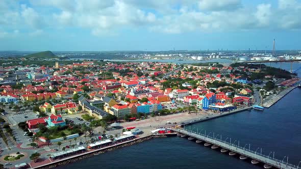 Aerial view dolly in of Otrobanda district in Willemstad, Curacao, Dutch Caribbean island. Refinery