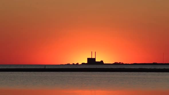 Sea sunset right behind power plant