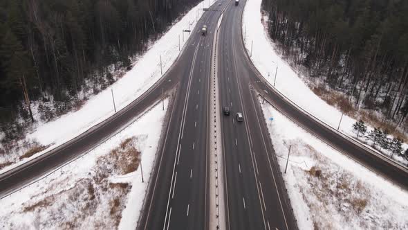 Suburban Long Highway with Fast Moving Trucks and Cars in Winter Aerial View