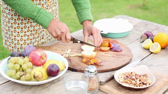 Woman cutting fruits outdoors