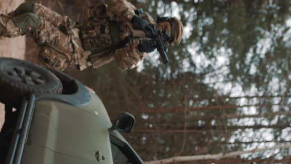 Vertical Video  Female Soldier Covering the Army Patrol Truck  Convoying the Humanitarian Transport