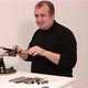 Man Shows a Master Class on Sharpening a Knife on a Machine - VideoHive Item for Sale