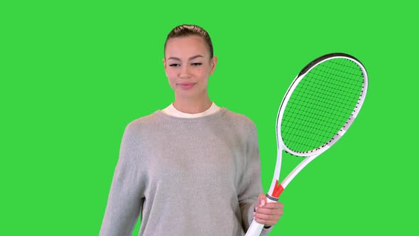 Female Tennis Player Walking and Tossing a Ball Up on a Green Screen Chroma Key