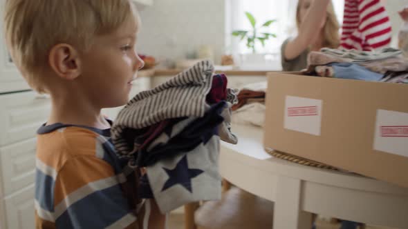 Tracking video of boy with clothes for donation. Shot with RED helium camera in 8K