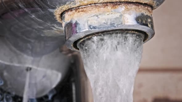 Faucet with Running Water in Slow Motion Macro Shot