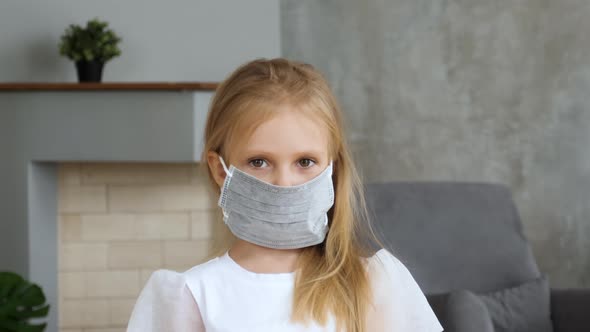 Girl wearing medical mask and looking to camera
