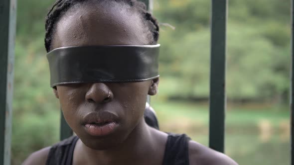 young African woman prisoner with blindfolded eyes-close up
