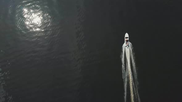 A Man Riding Motor Boat on Dark River