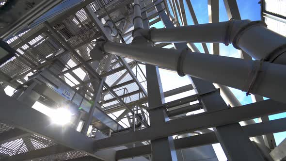 Industrial plant with pipes. Metal structure on a modern granary. 