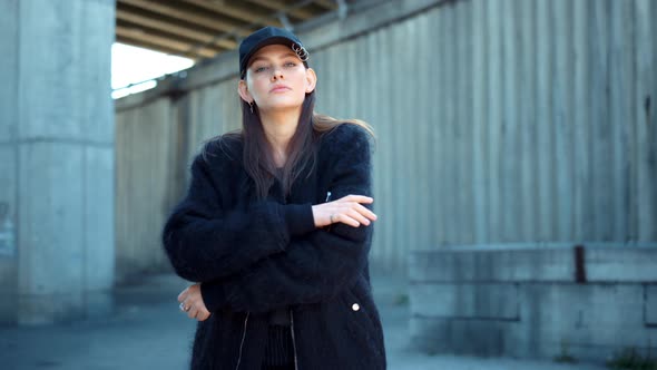 Girl Standing on Urban Street. Serious Woman Posing at Camera