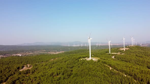 Aerial View Over the Farm Landscape and Wind Turbines Generating Clean Renewable Energy