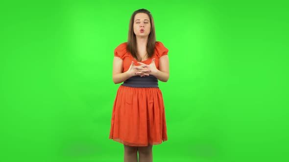 Cute Girl Talking About Something Pointing at Him, Copy Space. Green Screen