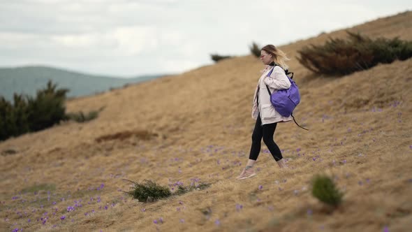 Young Traveller Woman Going Down Hiking in Mountain Alone