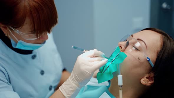 Face of a patient in protective glasses in the dental chair