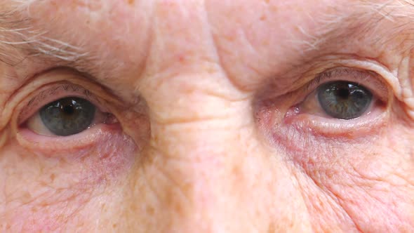 Portrait of Elderly Woman with Pensive Look. Old Woman Watching Pensive Into Camera and Closing Her