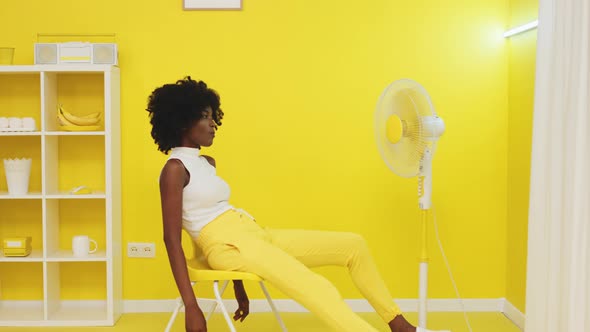 Young Black Woman In Yellow Office