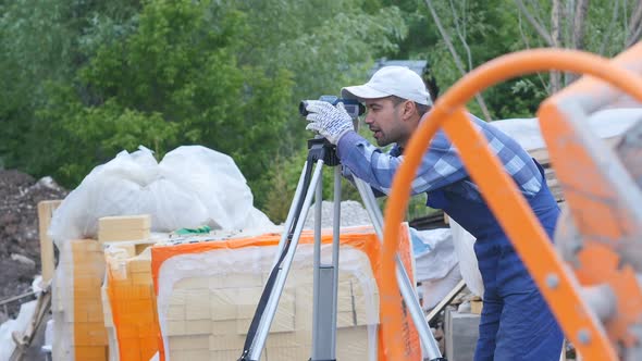 A Man Holds A Special Laser Measuring Device