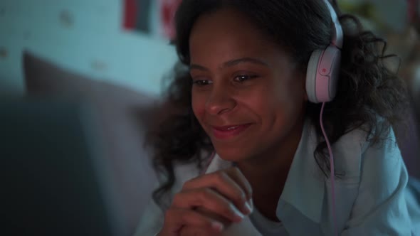 Smiling girl watching something on laptop