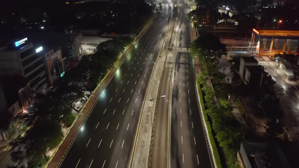 Low Flying Aerial Tilting Dolly Shot of Empty Multi Lane Road in Modern City Center with Skyscrapers