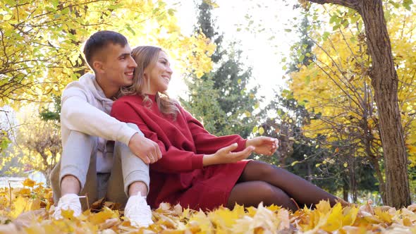 Playful Little Son Runs To Hug Mother Father in Autumn Park