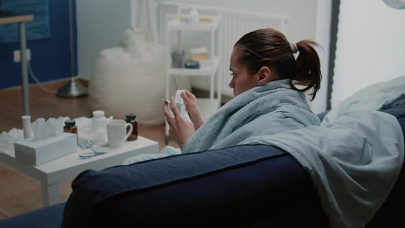 Ill Woman Reading Package Leaflet for Information About Medication