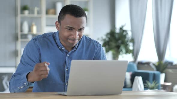 Angry Young African Man Reacting to Loss at Work