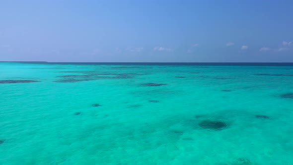 Wide drone abstract shot of a sunshine white sandy paradise beach and aqua blue water background in 