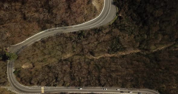 Aerial Autumn Road From Above View of Cars on a Zig Zag Road. Season Forest Road Landscape. Mountain