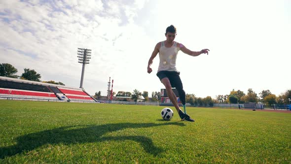 Disabled Man with a Bionic Leg Is Playing Football