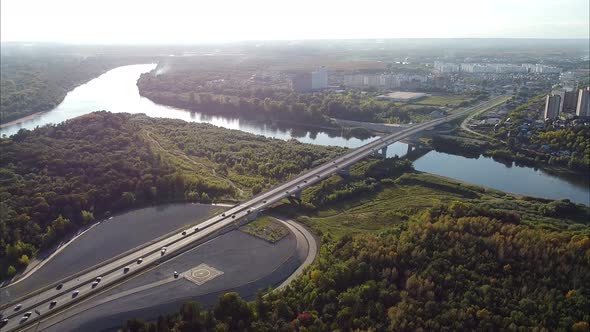 Views of the City's Outskirts a Bridge Over the River a Green Forest at Sunset a Bird'seye View