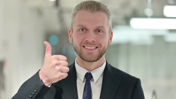Portrait of Positive Businessman Doing Thumbs Up 
