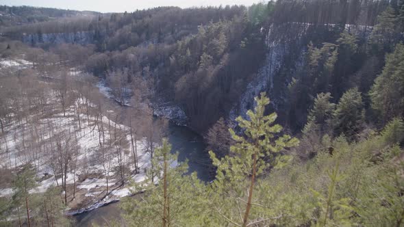 Wide Shot of River Running in a Forest Valley on a Bright Winter Day in Vilnius