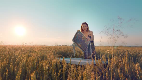 Woman Artist Who Paints a Picture of Ears of Wheat at Sunset. The Artist Paints a Picture with Ears