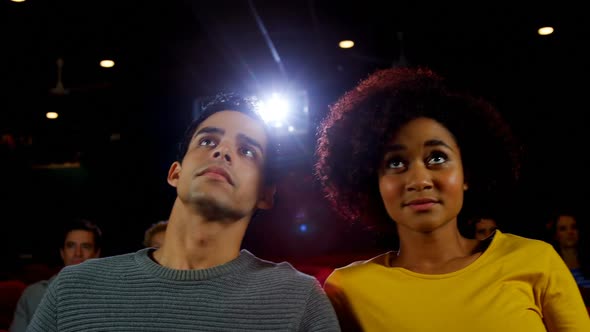 Couple watching movie in theater