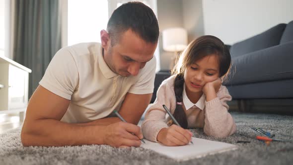 Father and Daughter Communicate Having Fun and Painting Together