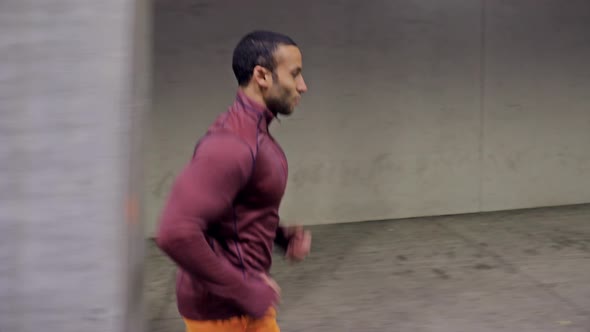 Athletic Male Running Through A Tunnel