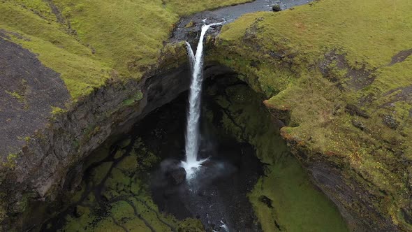 thin waterfall in the mountains of iceland