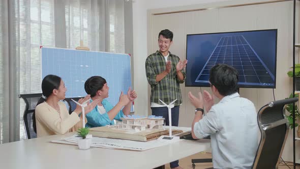 Asian Man Engineer Succeed Presenting About The Work Of Solar Cell, Audience Clapping Hands