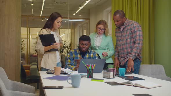 Business Partners Working at Office Using Laptop