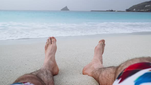 Mans Feet on Sandy Beach