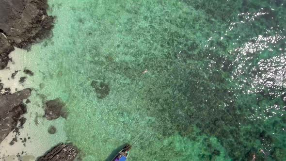 Girl lying on the turquoise water - Drone footage from Koh Phi Phi, Thailand