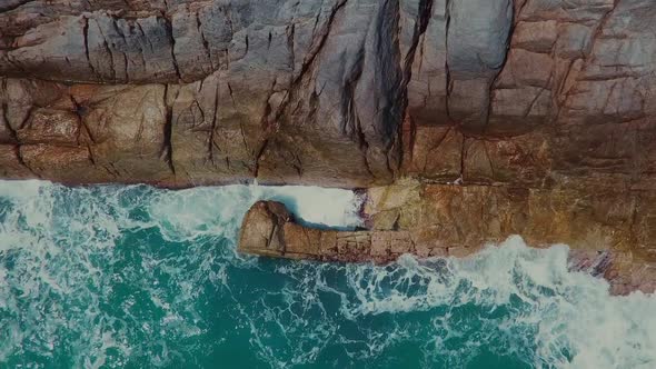 Aerial Footage of Waves Breaking Onto a Rocky Shore