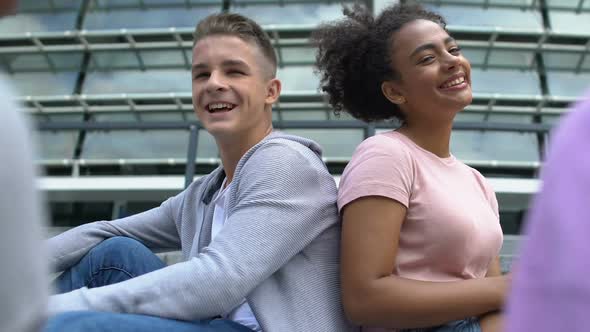 Biracial Girl Sitting Back to Caucasian Male Friend Communication and Friendship